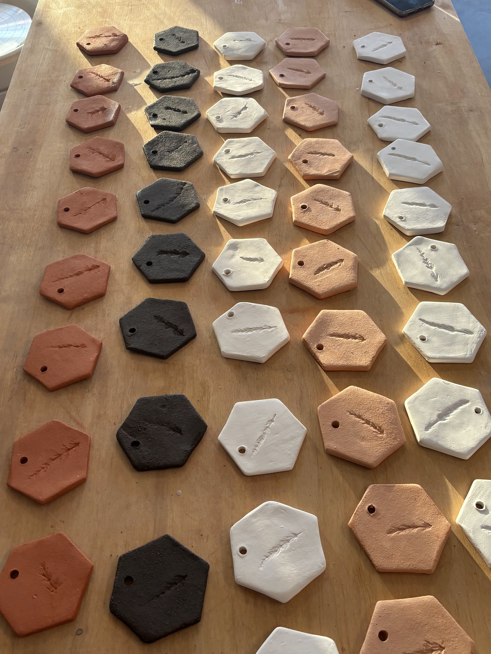 Photo of hexagonal test titles showing different clay bodies